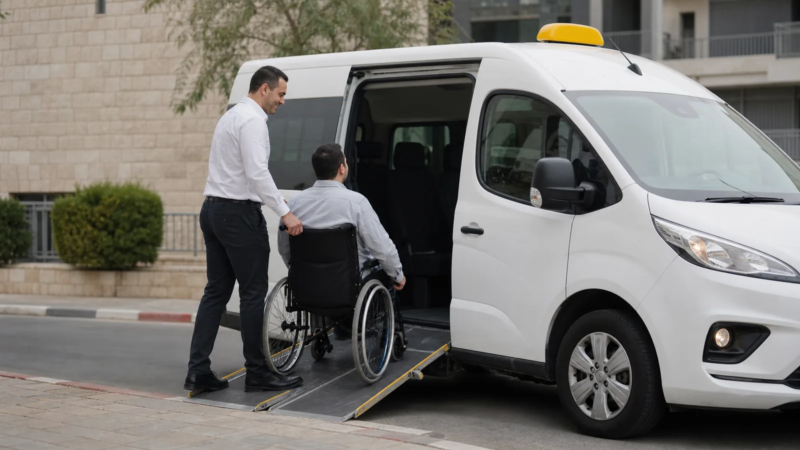 נהג מסייע לנוסע בכיסא גלגלים לעלות למונית נגישה לבנה באמצעות רמפה